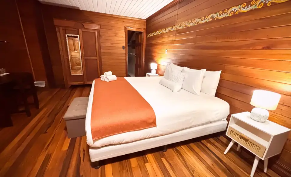 Junior Suite — Warm wood and copper tones